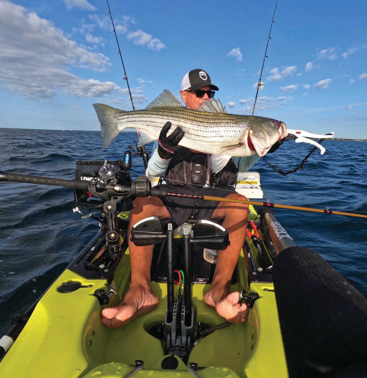 STRIPED BASS BITE STILL STRONG: Tom Houde of West Warwick with the 39-inch striped bass he caught trolling tube & worm with his kayak off Newport at Brenton Reef.